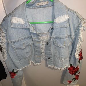 jean jacket with rose sleeved arms